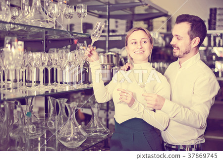 Couple looking at assortment of glasses 37869745