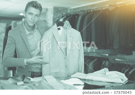 Adult male selling jacket in the store 37870045