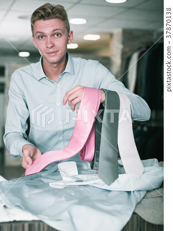 Portrait of man customer choosing tie 37870138