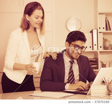 Business couple flirting in office 37870160