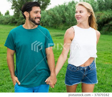 Couple is talking in time walking on nature Couple is talking in time walking on nature 37870162