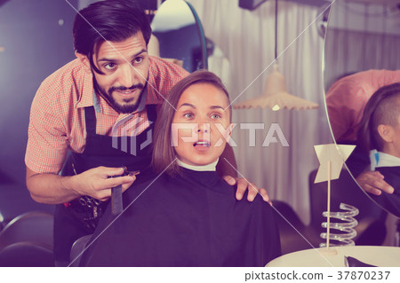 Male professional with female talking about hairstyle 37870237
