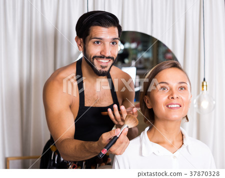 Professional makeup artist applying cosmetics Professional makeup artist applying cosmetics 37870328