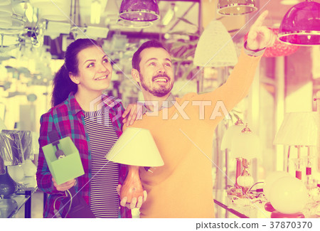 Guy and girl making a purchase of a lamp 37870370