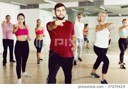 Smiling people of different ages practice sport 37870429