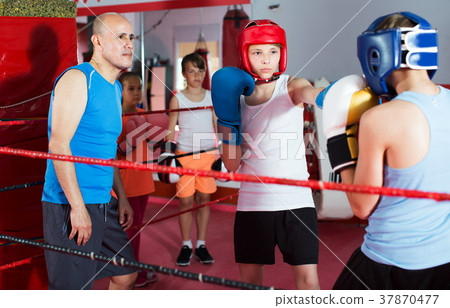 Children training on boxing ring Children training on boxing ring 37870477