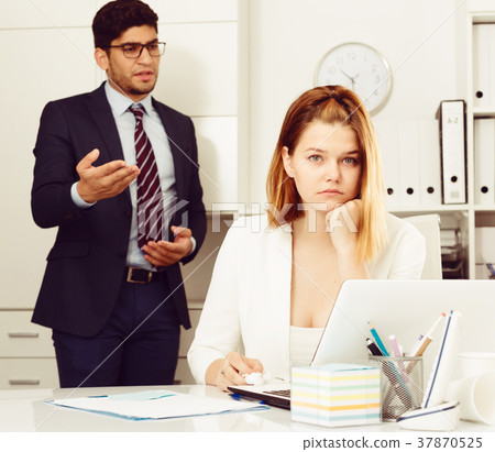 Frustrated business woman with angry chief Frustrated business woman with angry chief 37870525