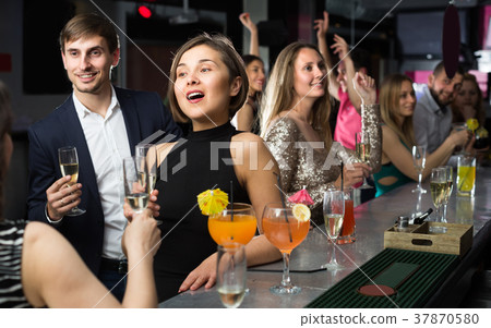 Young girl is drinking cocktails with colleague 37870580