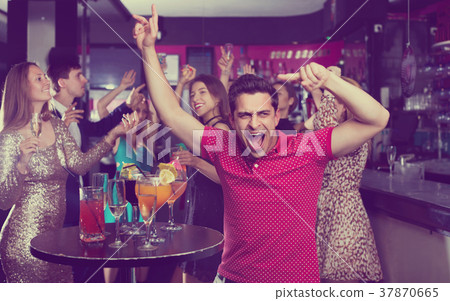 Portrait of smiling females and males having fun in the bar 37870665