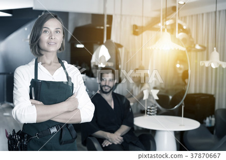 smiling woman hairdresser with male visitor 37870667