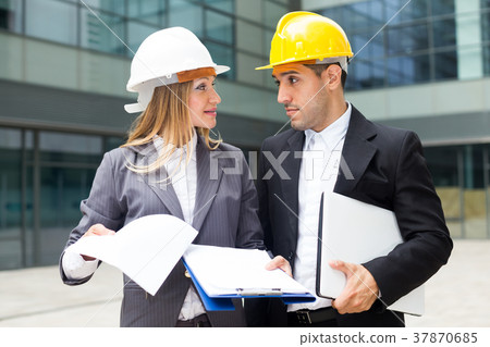 Smiling female designer and her partner are estimating results of their project Smiling female designer and her partner are estimating results of their project 37870685