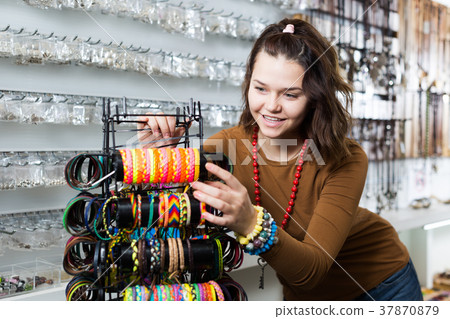 Woman offering to buy fashionable bracelets Woman offering to buy fashionable bracelets 37870879