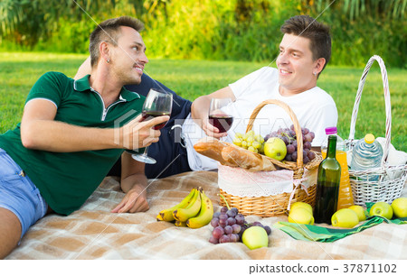 Young males drink wine and socialize 37871102
