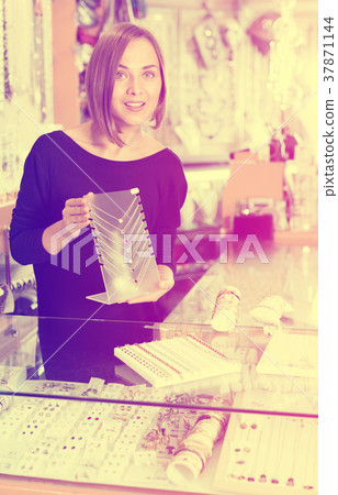 Woman worker showing pendants 37871144