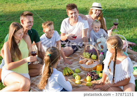 Portrait of parents with children on picnic in nature at summer Portrait of parents with children on picnic in nature at summer 37871151