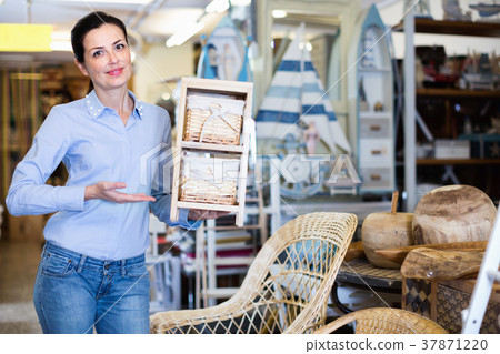 Adult woman customer standing with wicker basket in shop for decor 37871220