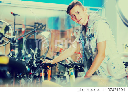 boy choosing new bicycle 37871304