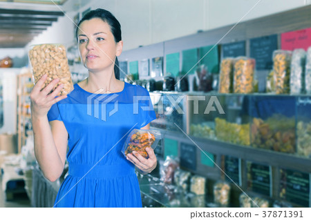 Woman taking nut beans in shop Woman taking nut beans in shop 37871391