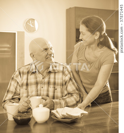 mature woman serving toast to happy man mature woman serving toast to happy man 37871445