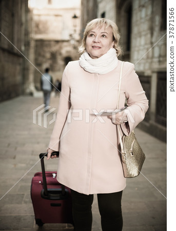 mature female tourist holding map mature female tourist holding map 37871566
