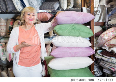 elderly woman purchaser holding pillows elderly woman purchaser holding pillows 37871753
