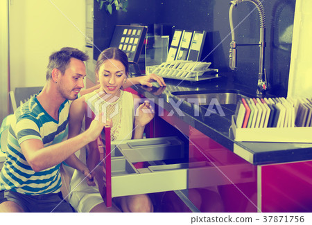 happy family couple looking at kitchen tabletop in furniture workshop happy family couple looking at kitchen tabletop in furniture workshop 37871756