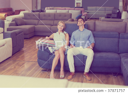 Happy couple are choosing sofa 37871757