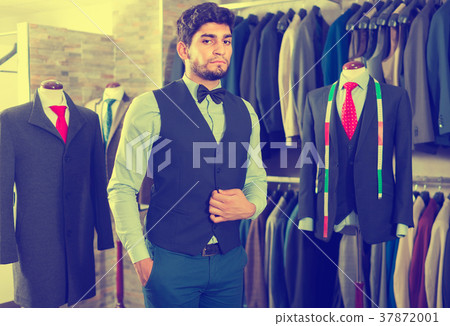 Young male is demonstrating image in waistcoat with butterfly 37872001