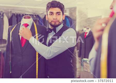 Salesman is creating business image with red tie Salesman is creating business image with red tie 37872011