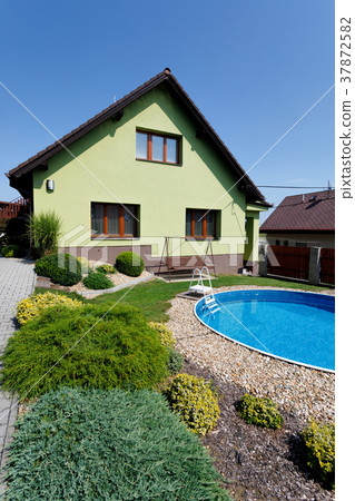 beautiful green colored rural house 37872582