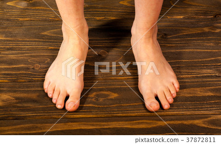 Close up a woman with itchy feet uses his big toe Close up a woman with itchy feet uses his big toe 37872811