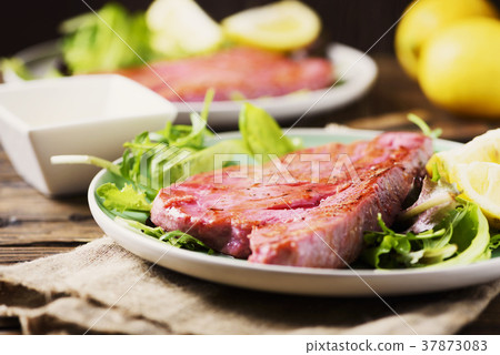 Cooked delicious tuna fish with green salad Cooked delicious tuna fish with green salad 37873083