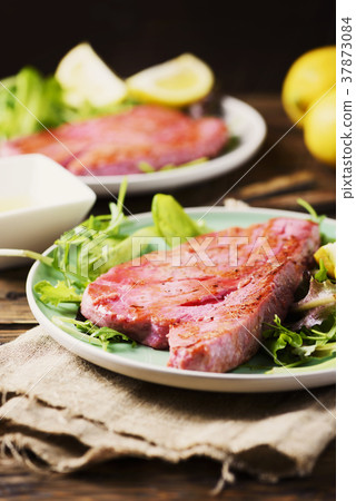 Cooked delicious tuna fish with green salad Cooked delicious tuna fish with green salad 37873084