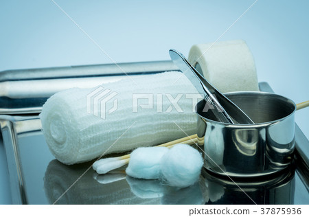 Wound care dressing set on stainless steel plate. 37875936