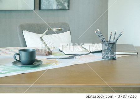 Magnifying glass,book and pencils on working table Magnifying glass,book and pencils on working table 37877216