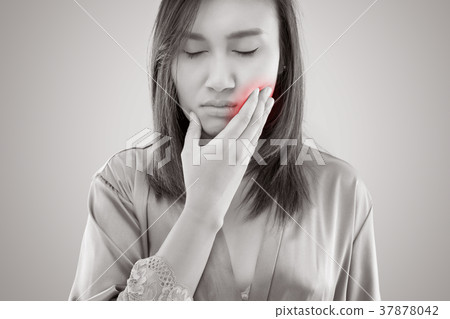 Suffering from toothache. Beautiful young woman suffering from t Suffering from toothache. Beautiful young woman suffering from t 37878042