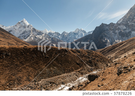 Ama Dablam mountain. Sun illuminates slopes Ama Dablam mountain. Sun illuminates slopes 37878226