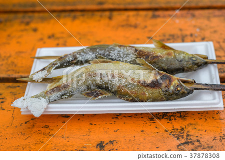Grilled trout fish on wooden table 37878308