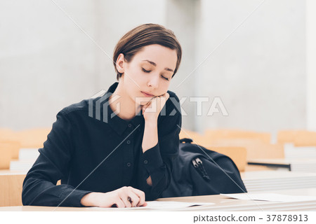 Young women in class (boredness, sleepiness, fatigue) 37878913