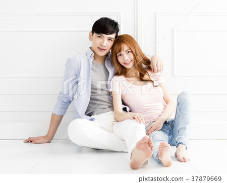 relaxed couple sitting together on the floor relaxed couple sitting together on the floor 37879669