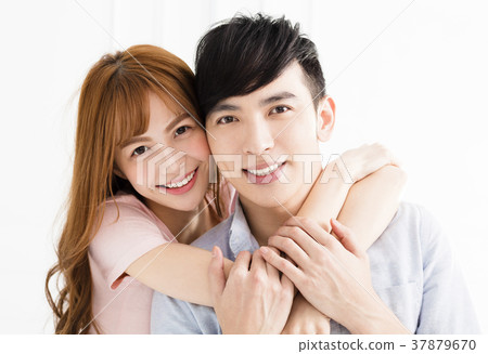 happy young asian couple hugging in living room 37879670