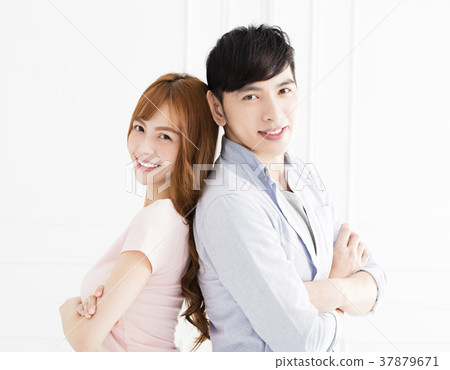 happy young asian couple standing in living room 37879671
