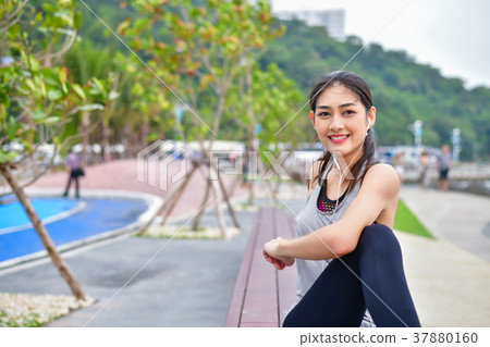 Sports concept. Beautiful girl is exercising on the beach with w 37880160