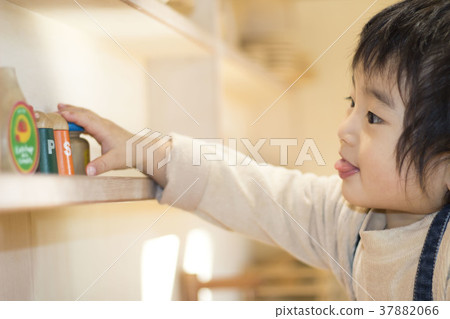 Boy reaching for the cupboard Boy reaching for the cupboard 37882066