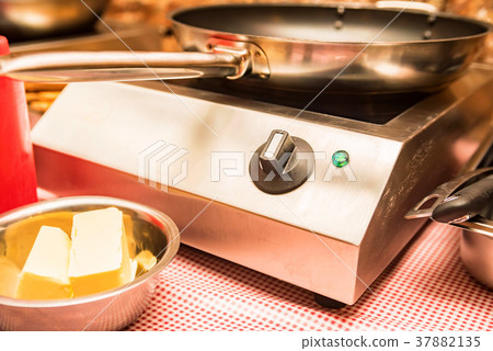 Close up small cooktop with frying pan on it Close up small cooktop with frying pan on it 37882135