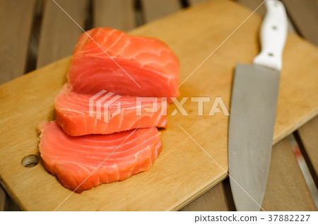 Sliced salmon fillet on cutting board 37882227