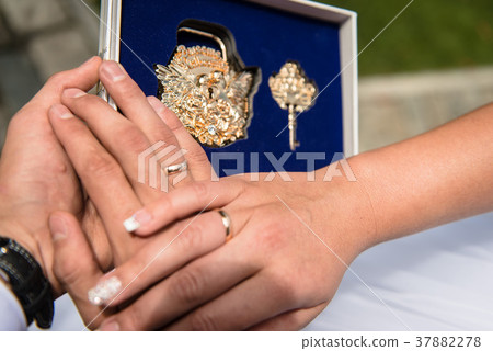 Close up hands of newlywed and wedding lock Close up hands of newlywed and wedding lock 37882278