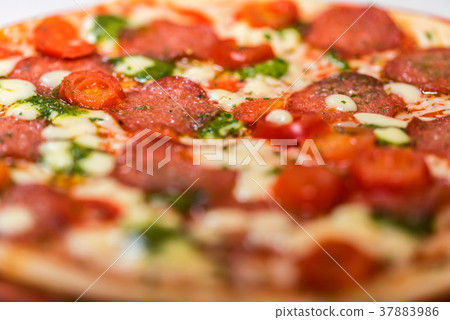 Delicious fresh pizza with tomatoes, salami close Delicious fresh pizza with tomatoes, salami close 37883986