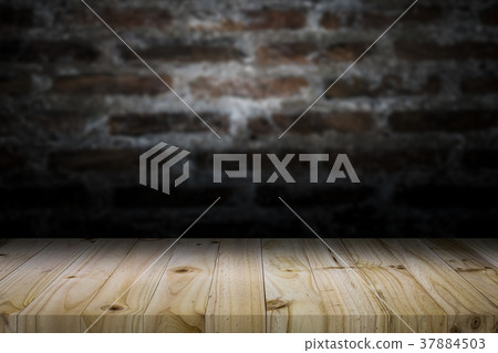 Wood table top on old dark brick wall background. Wood table top on old dark brick wall background. 37884503
