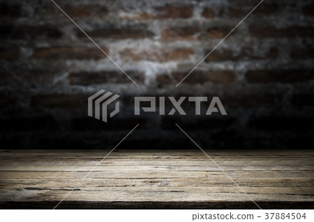 Wood table top on old dark brick wall background. Wood table top on old dark brick wall background. 37884504